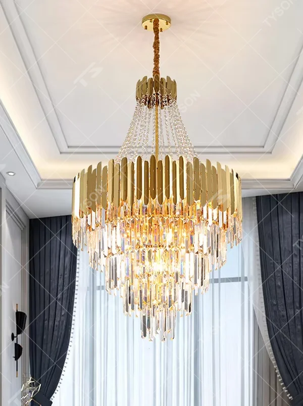 This light luxury and grand multi-layer crystal chandelier features a gold metal frame, paired with transparent crystal pendants and metal decorative pieces, creating a layered conical shape. When lit, light refracts through the crystal to emit a brilliant and luxurious glow, combining decorative appeal with an ambient atmosphere. Ideal for villa living rooms, high-ceiling spaces, hotel lobbies, or duplex foyers, it adds an elegant and exquisite touch to modern light luxury or European-style luxury spaces.