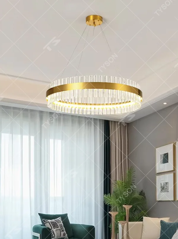 This modern light luxury circular crystal chandelier features a gold metal frame, inlaid with transparent long crystals to form a double-layered circular shape. When lit, light refracts through the crystal to emit a brilliant and soft glow, combining an exquisite texture with an ambient atmosphere. Ideal for living rooms, dining rooms, light luxury apartments, and other spaces, it adds an exquisite and sophisticated touch to modern minimalist or light luxury home environments.