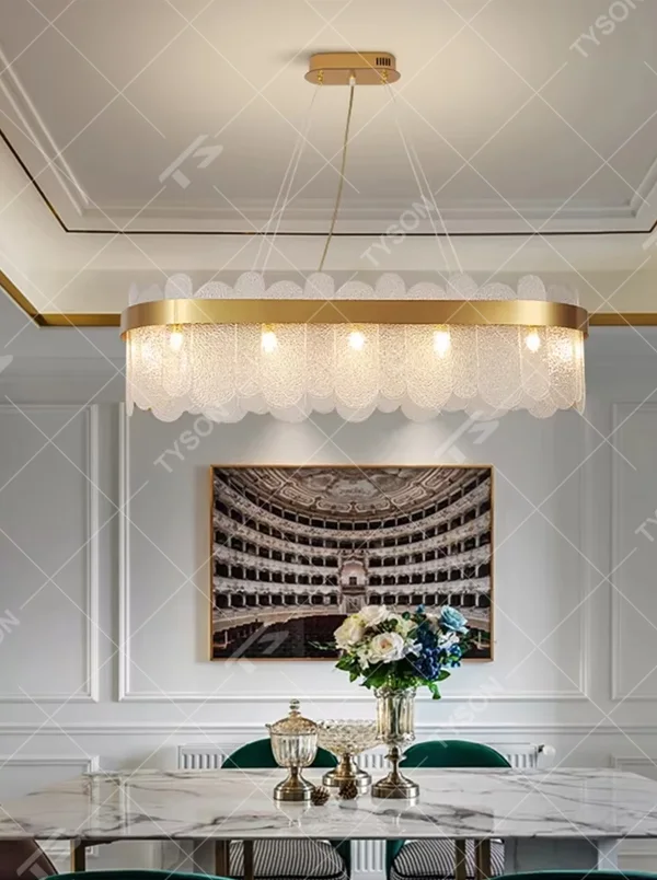 Modern light luxury smoky gray glass chandelier, featuring a ring frame in gold metal paired with layered smoky gray curved glass panels. Light refracts through the glass to create a soft and translucent glow, combining sophistication and ambiance, making it a decorative lighting fixture that elevates the space's style.
