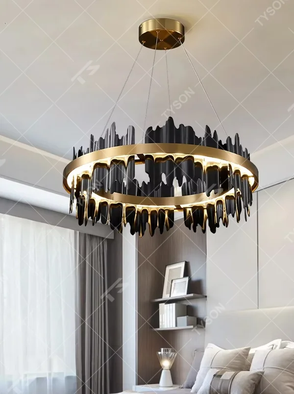 Modern light luxury black and gold ring chandelier, featuring irregular black and gold metal pieces to create a lava-like flowing shape. Light shines through the gaps between the metal rings, combining artistry and ambiance, making it a high-end decorative lighting fixture that elevates the space's style.
