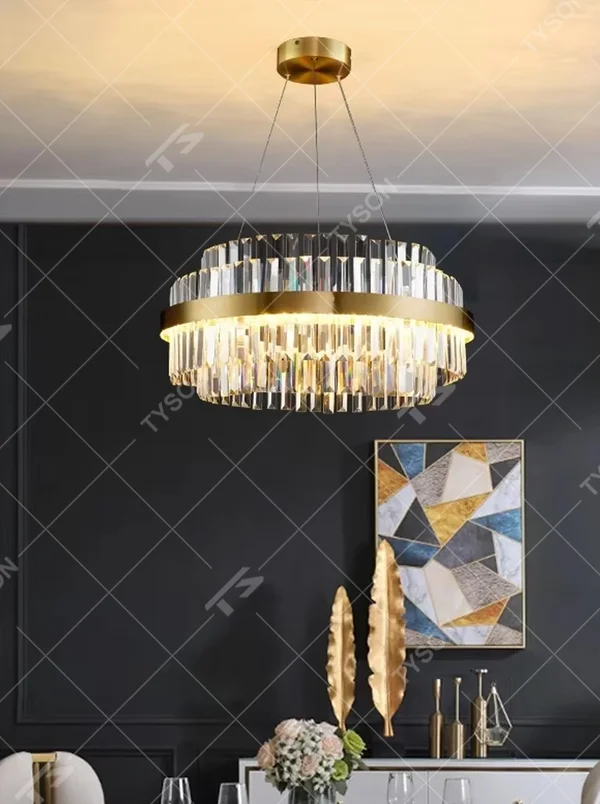 This modern light luxury two-layer circular crystal chandelier features a gold metal frame, with dense transparent long crystals hanging down to form a full circular shape. When lit, light refracts through the crystal to emit a brilliant and soft glow, combining a luxurious texture with an ambient atmosphere. Ideal for dining rooms, living rooms, light luxury apartments, and other spaces, it adds an exquisite and sophisticated touch to modern minimalist or light luxury home environments.