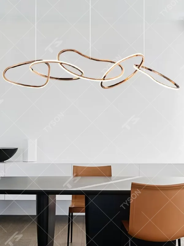Modern light luxury flowing ring chandelier, featuring interwoven and irregular gold metal rings with built-in soft LED lighting. Its dynamic and elegant lines combine artistry and ambiance, making it a high-end decorative lighting fixture that elevates the space's style.