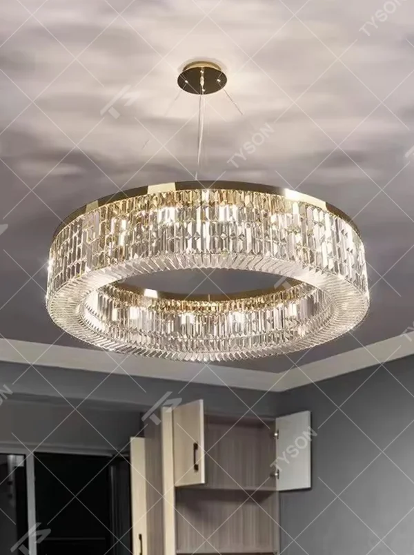 This modern light luxury two-layer circular crystal chandelier features a gold metal frame, inlaid with transparent long crystals to form a double-layered circular shape. When lit, light refracts through the crystal to emit a brilliant and soft glow, combining an exquisite texture with an ambient atmosphere. Ideal for living rooms, dining rooms, light luxury apartments, and other spaces, it adds an exquisite and sophisticated touch to modern minimalist or light luxury home environments.