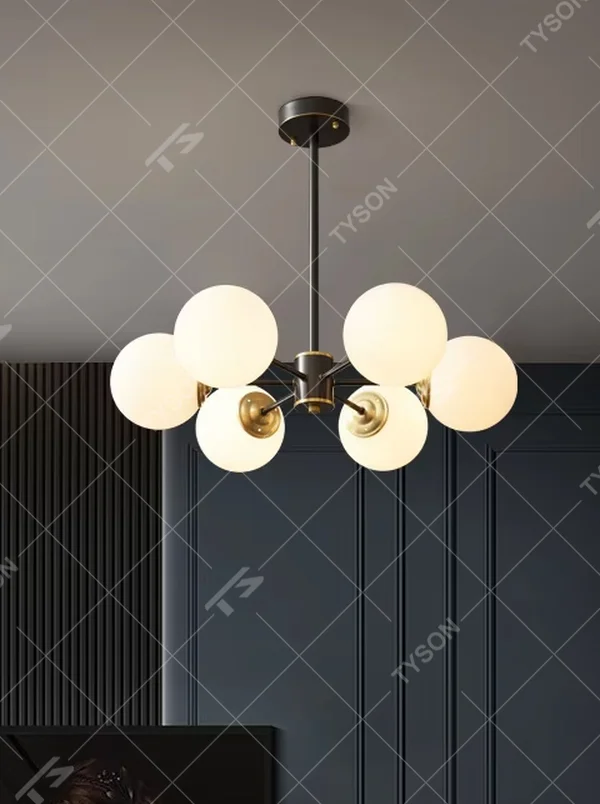 Modern light luxury magic bean chandelier, featuring a radial frame in black and gold metal paired with milk-white frosted glass ball lampshades. Its minimalist, rounded, and layered design combines warmth and style, making it a decorative lighting fixture that enhances the space's texture.