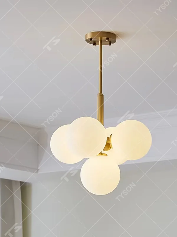 Modern light luxury gold magic bean chandelier, featuring a brass metal frame paired with clustered milk-white frosted glass balls. It emits soft and gentle light, combining warmth and style, making it a decorative lighting fixture that enhances the space's texture.