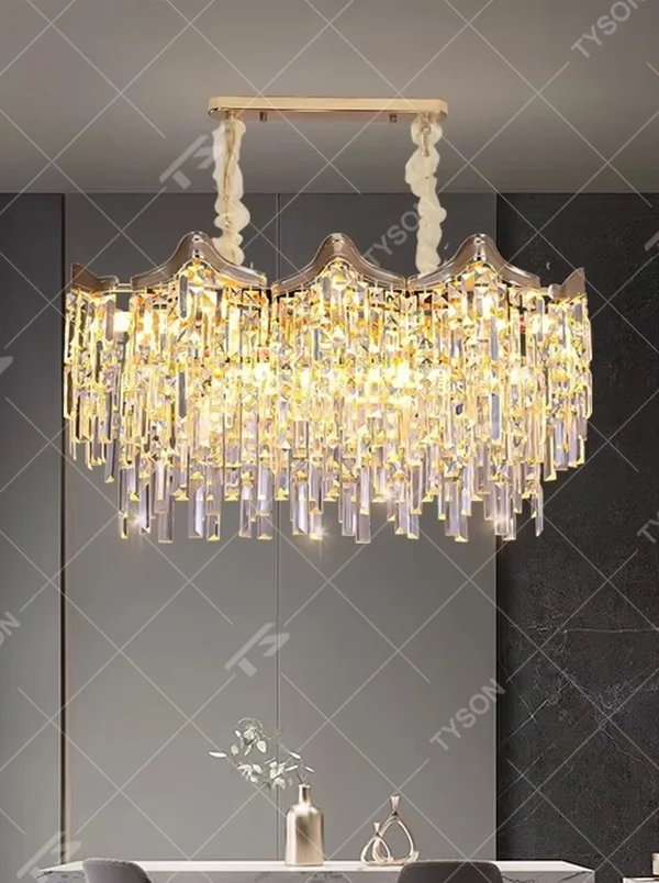 This European luxury fan-shaped crystal chandelier features a champagne gold metal frame, with dense long crystals hanging down to form a layered fan shape, suspended by a braided cord. When lit, light refracts through the crystal to emit a brilliant and luxurious glow, combining a luxurious texture with an ambient atmosphere. Ideal for villa living rooms, luxury dining rooms, high-end clubs, and other spaces, it adds an elegant and exquisite touch to European luxury or modern light luxury environments.