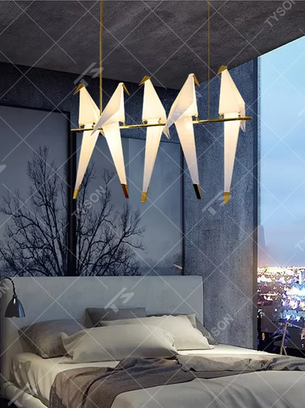 Modern art origami crane chandelier, featuring a gold metal frame paired with white origami crane-shaped lampshades made using paper folding techniques. Its elegant and dynamic lines combine artistry and ambiance, making it a decorative lighting fixture that elevates the space's style.