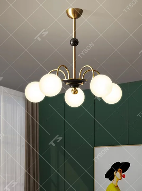 Modern light luxury black and gold magic bean chandelier, featuring curved brackets in black and gold metal paired with milk-white frosted glass ball lampshades. Its rounded, soft, and layered design combines warmth and style, making it a decorative lighting fixture that enhances the space's texture.