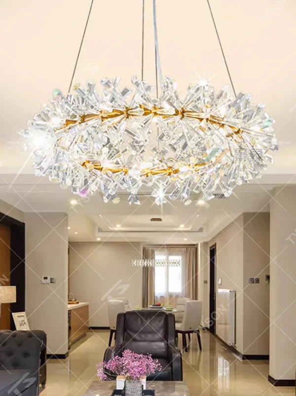 This modern light luxury two-layer circular chandelier features a gold metal frame, inlaid with transparent snowflake-shaped crystal modules, combined into a two-layer staggered circular shape. When lit, light refracts through the crystal to emit a brilliant and soft glow, combining an ethereal feel with an ambient atmosphere. Ideal for living rooms, dining rooms, light luxury apartments, and other spaces, it adds a dreamy and exquisite touch to modern minimalist or French light luxury home environments.