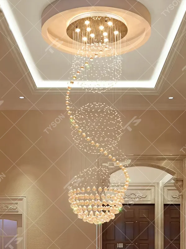 This European luxury spiral staircase crystal chandelier features a metal ceiling base, with dense crystal bead strings hanging down to form a dynamic spiral-rising shape. When lit, light refracts through the crystal to emit a brilliant and soft glow, combining a dynamic texture with an ambient atmosphere. Ideal for villa high-ceiling living rooms, hotel lobbies, duplex hollow spaces, and other areas, it adds an elegant and exquisite touch to European luxury or modern light luxury environments.