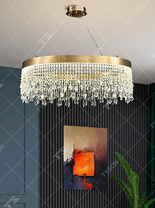 This modern light luxury circular tassel crystal chandelier features a champagne gold metal top frame, with dense crystal bead strings hanging down to form a tassel layered shape. When lit, light refracts through the crystals to emit a brilliant and soft glow, combining a luxurious texture with an ambient atmosphere. Ideal for living rooms, dining rooms, light luxury apartments, and other spaces, it adds an exquisite and sophisticated touch to modern minimalist or light luxury home environments.